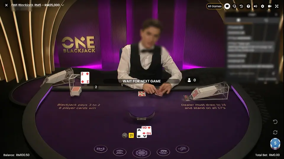 ONE Blackjack live table: purple felt with the ONE Blackjack logo behind a dealer in a waistcoat and bow tie (face blurred), cards on the table, a WAIT FOR NEXT GAME banner and a chat panel on the right (blurred)