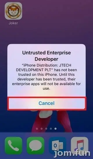 Untrusted Enterprise Developer pop-up naming iPhone Distribution: JTECH DEVELOPMENT PLT, Cancel button outlined in red, Joker icon in the top-left corner