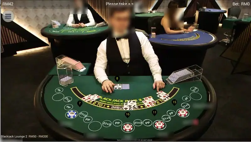 NTC33 live blackjack table Blackjack Lounge 2 with a dealer at a green seven-seat table, BLACKJACK PAYS 3 TO 2 and INSURANCE printed on the felt, PP and 21+3 circles at each seat, limit RM50 - RM200